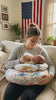Mom feeding her baby with the Mamora nursing pillow